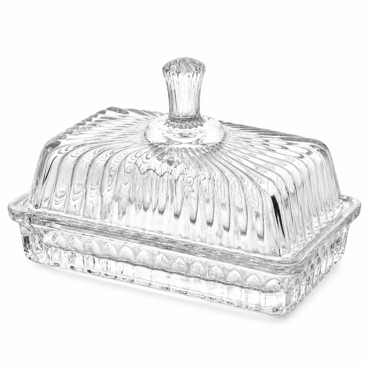 Ribbed glass butter dish with lid on a white background