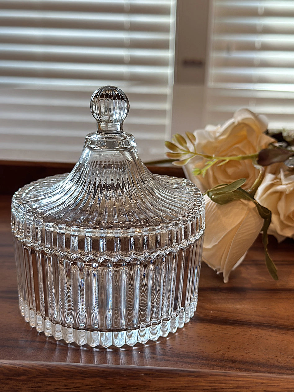Close view of the fluted glass jar sides and finial lids