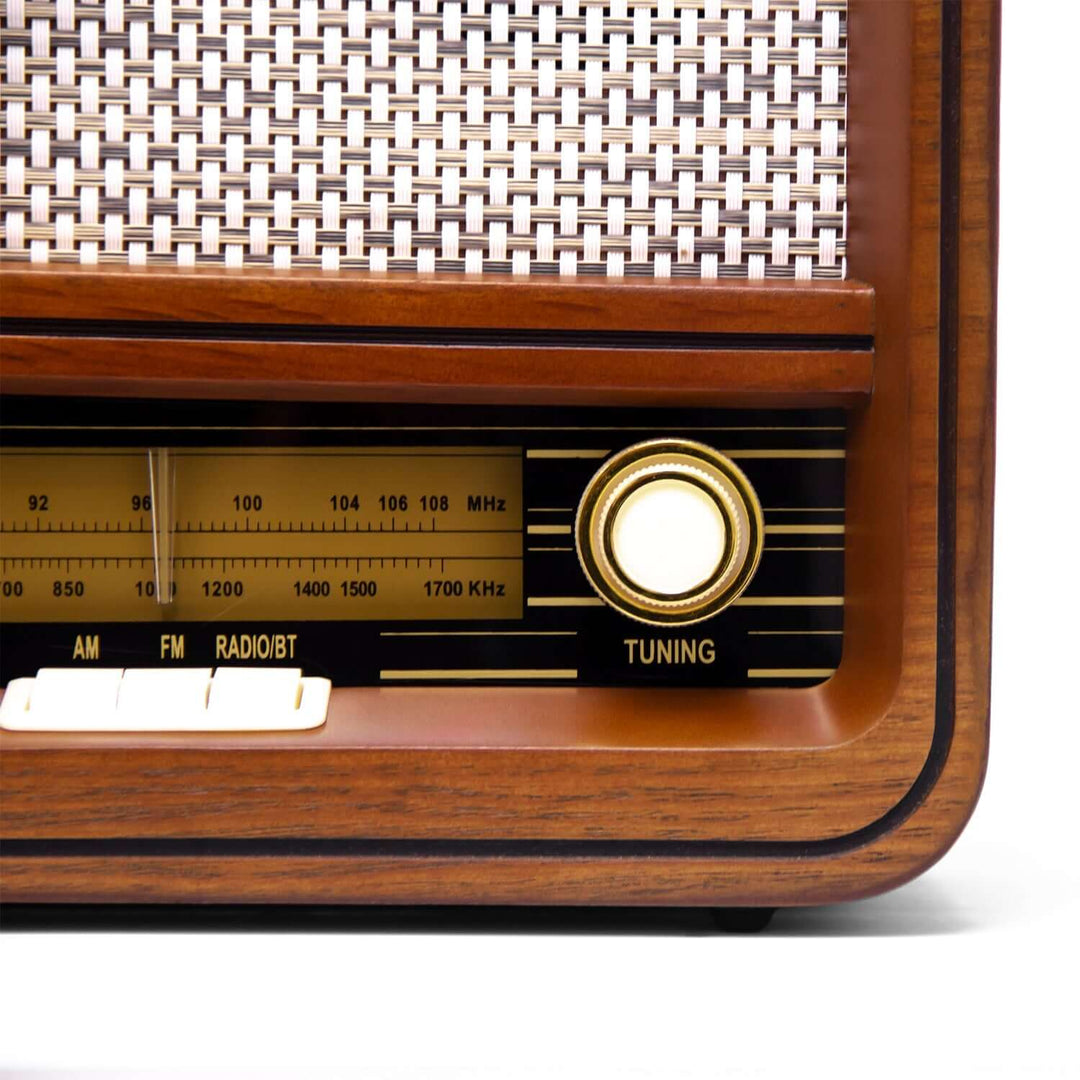 Close-up of a vintage radio with wooden casing and wicker back.