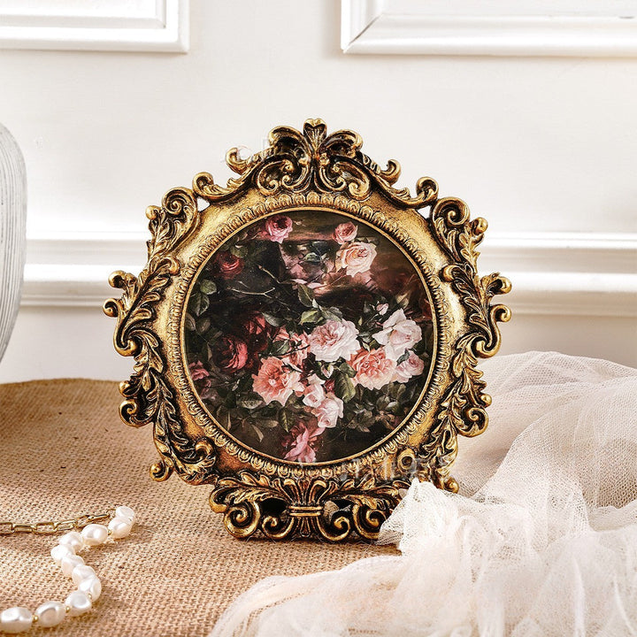 Rococo Round Gold Photo Frame styled with dark floral artwork
