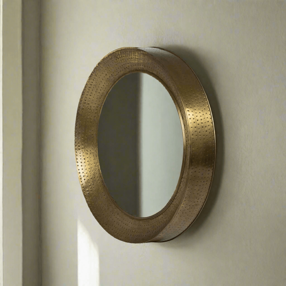 Round hammered brass wall mirror with vintage iron porthole design, adding old-world charm and elegance to any space.