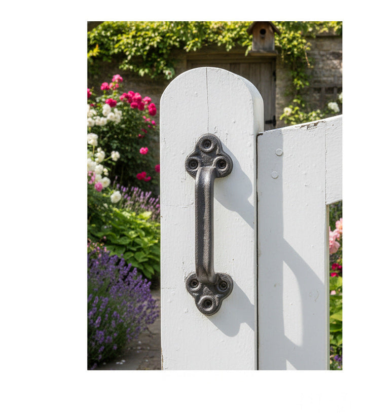 Cast iron door pull handle shown on a white garden gate
