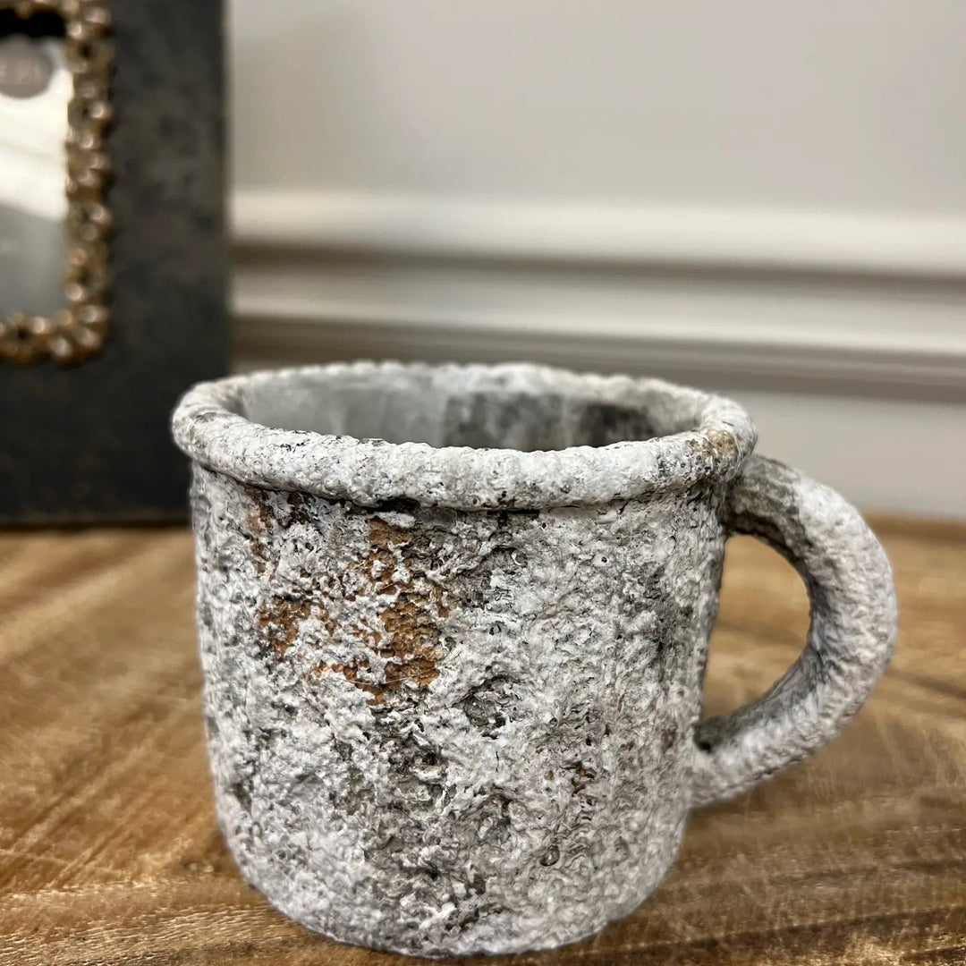 Close view of the cement texture and curved mug handle