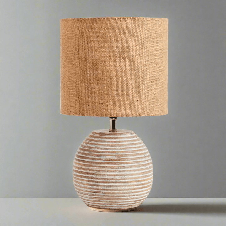 Rustic mango wood table lamp with linen shade, ribbed base and warm texture for elegant home decor.