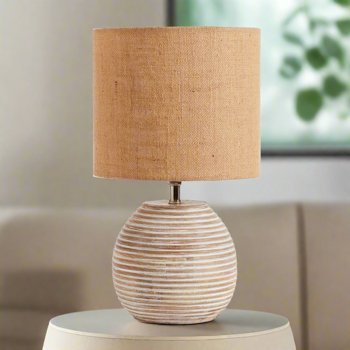 Rustic mango wood table lamp with ribbed base and warm linen shade for elegant home decor.