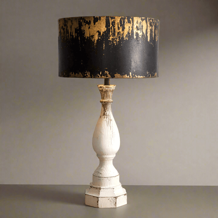 Rustic table lamp featuring a distressed metal shade and white wooden base, adding vintage charm to home decor.