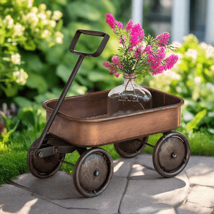 Rustic vintage farmhouse wagon in copper showcasing flowers, perfect for garden decor or tabletop display.