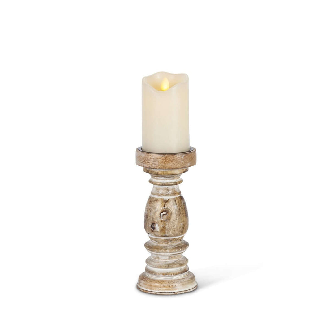 Rustic whitewashed mango wood pillar candle holder with hand-carved design, 9.25 inches tall, holding a lit candle.