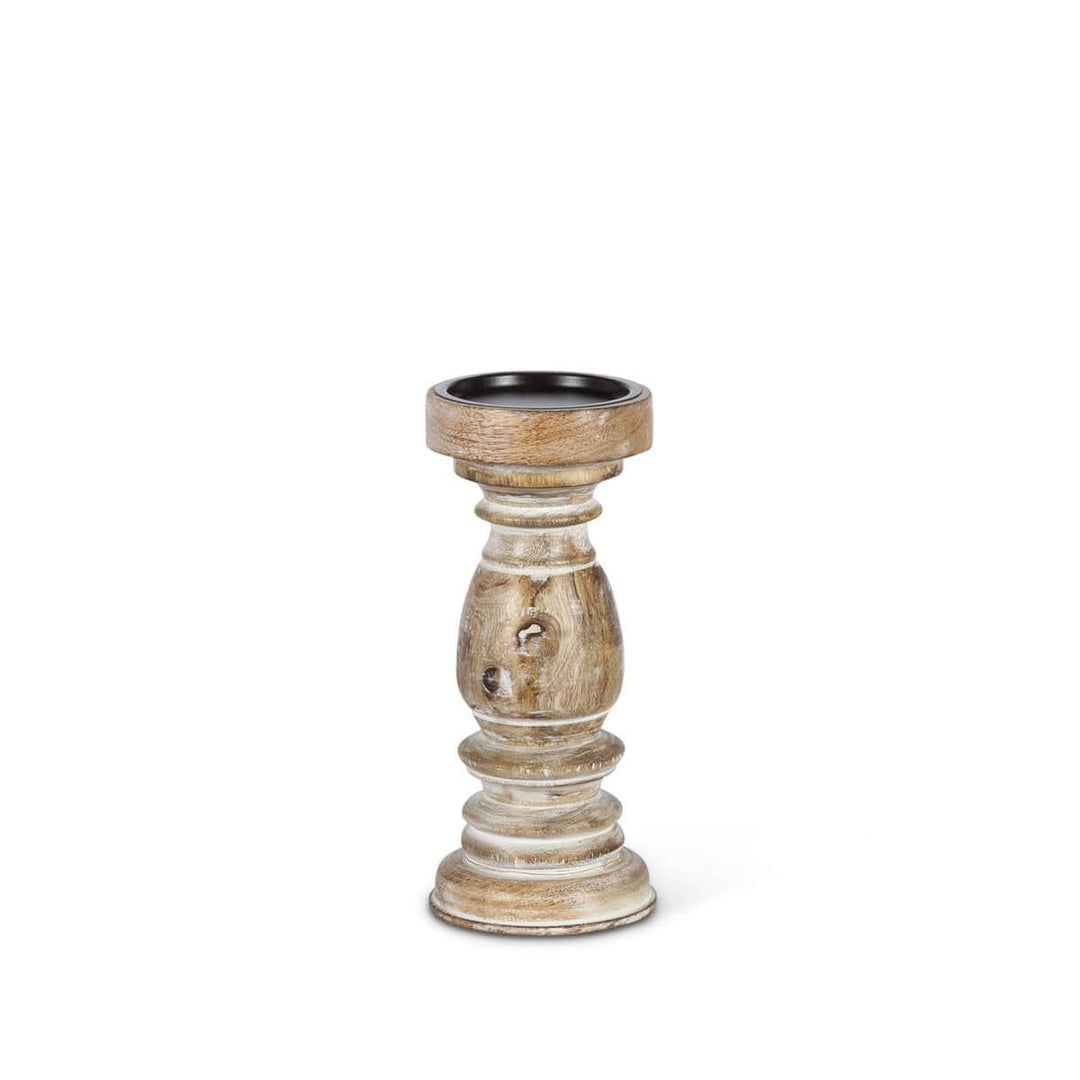 Rustic whitewashed mango wood pillar candle holder with intricate hand-carved design showcasing natural grain and knots.