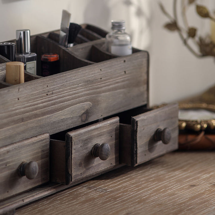 Close-up of the weathered wood grain and rounded drawer knobs