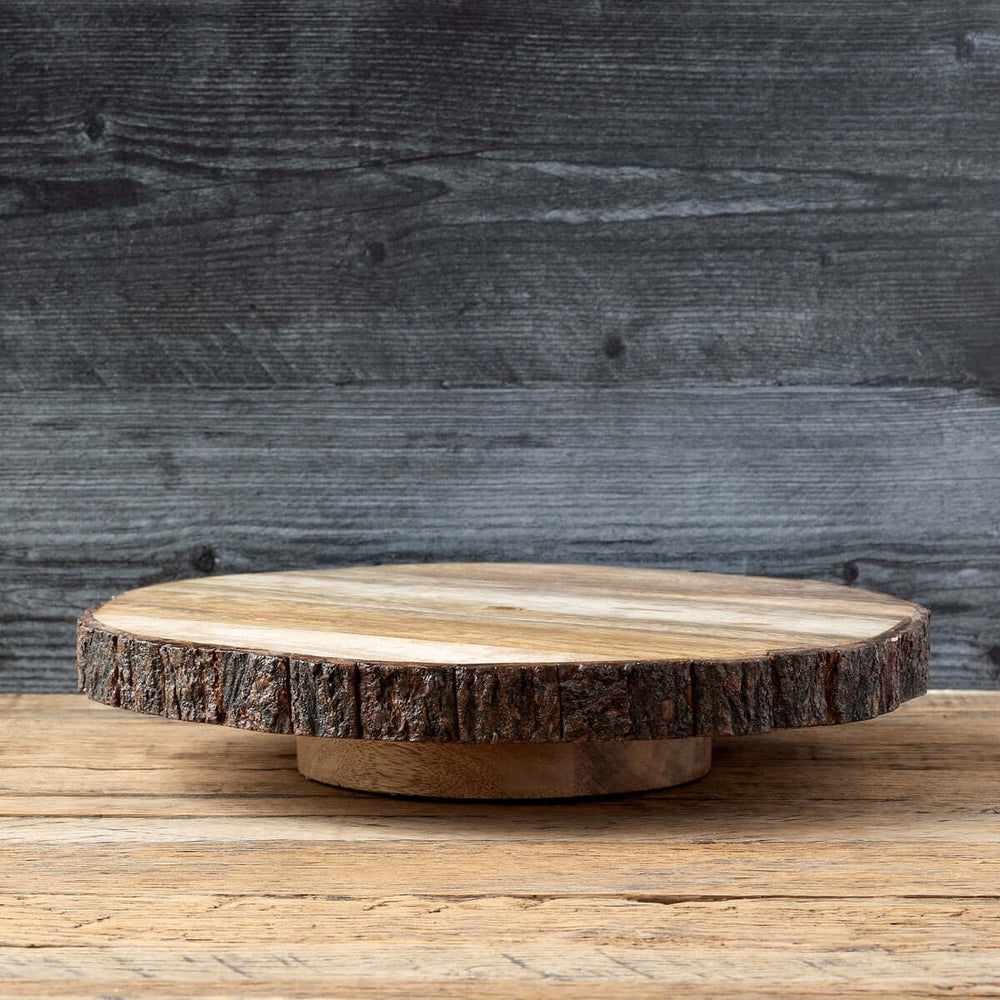 Rustic wood slice lazy Susan with bark edge, handcrafted for vintage charm and functionality on farmhouse tables.
