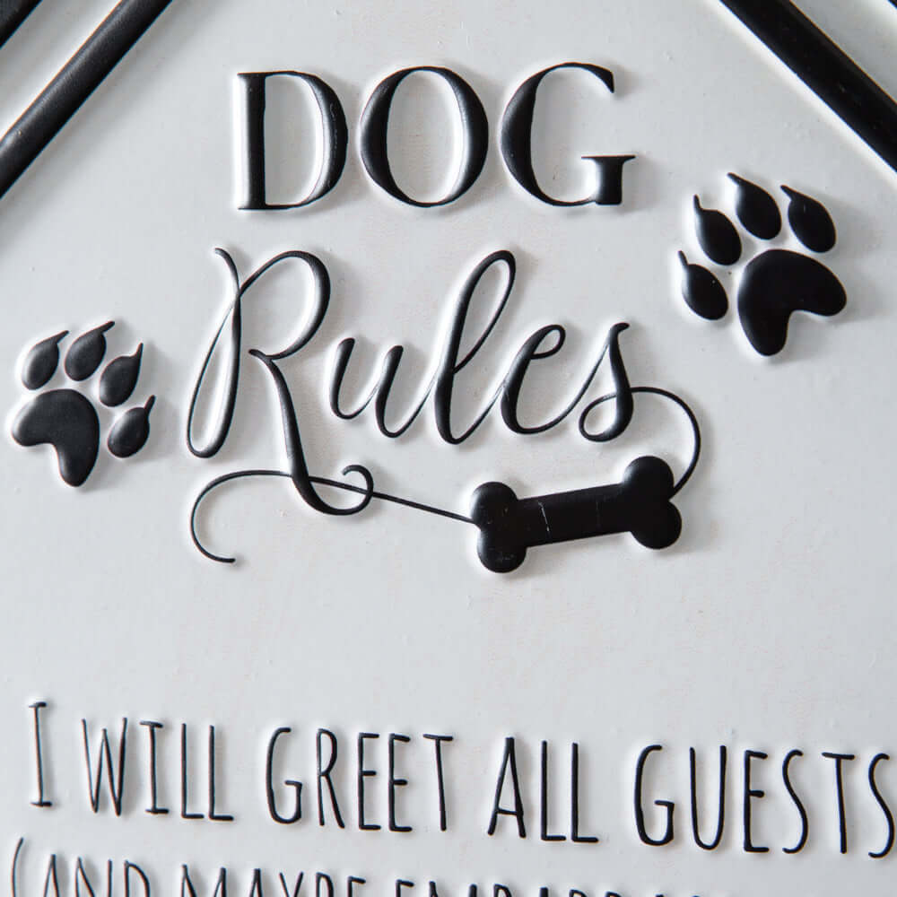 Close-up of Rustic Dog Rules Wall Sign with embossed black lettering and paw prints, highlighting whimsical house-shaped design.