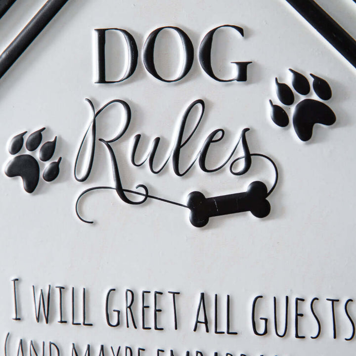 Close-up of Rustic Dog Rules Wall Sign with embossed black lettering and paw prints, highlighting whimsical house-shaped design.