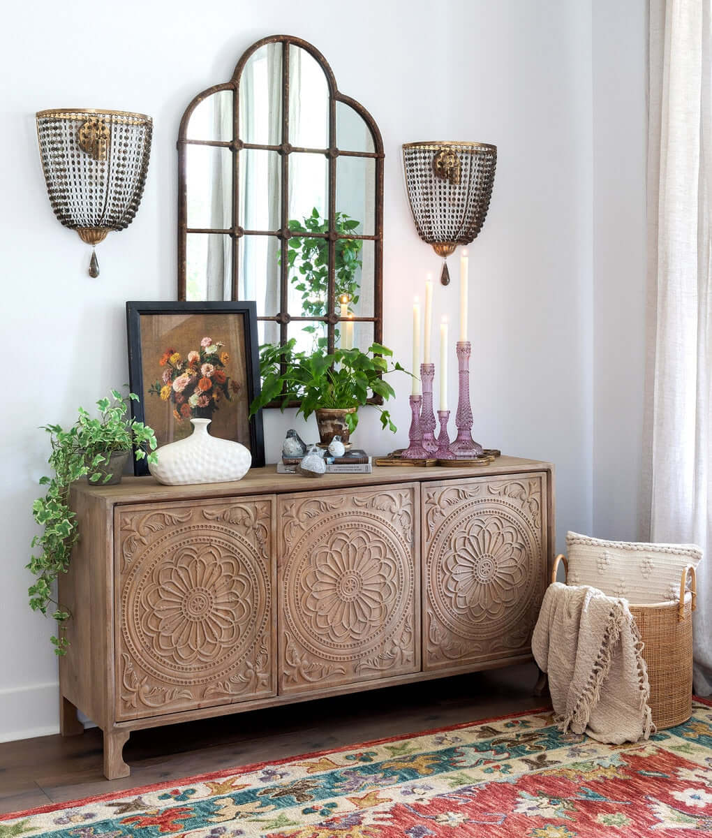 Rustic farmhouse iron windowpane mirror with wooden cabinet and decor.