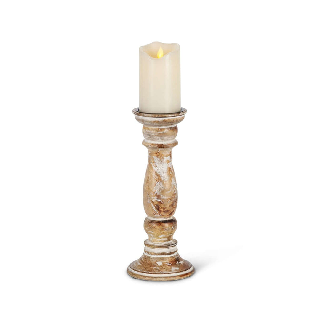 Rustic farmhouse whitewashed wood candle holder with a lit candle.