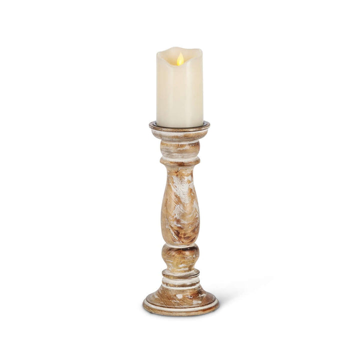 Rustic farmhouse whitewashed wood candle holder with a lit candle.
