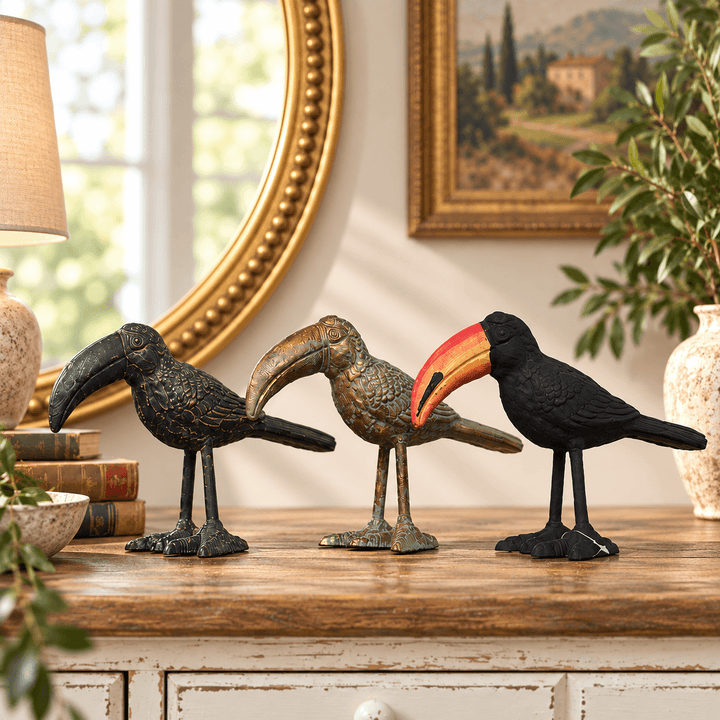 Three Sculpted Iron Toucan Figurine color options on a wood console
