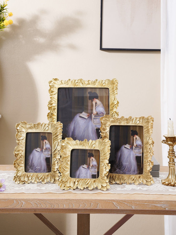 Collection of gold sculpted leaf photo frames in multiple sizes