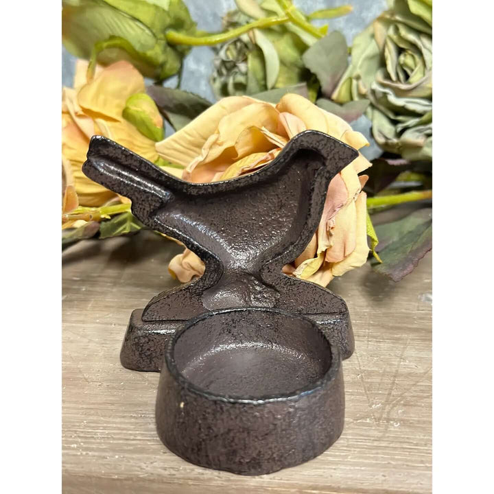 Rear view of the sculpted bird candle stand showing its integrated round candle cup