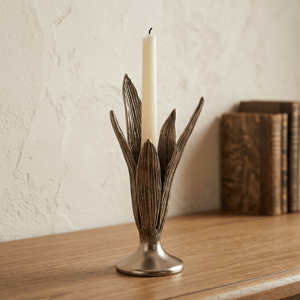 Small Sculpted Tulip Leaf Candle Holder with an ivory taper on a wooden console