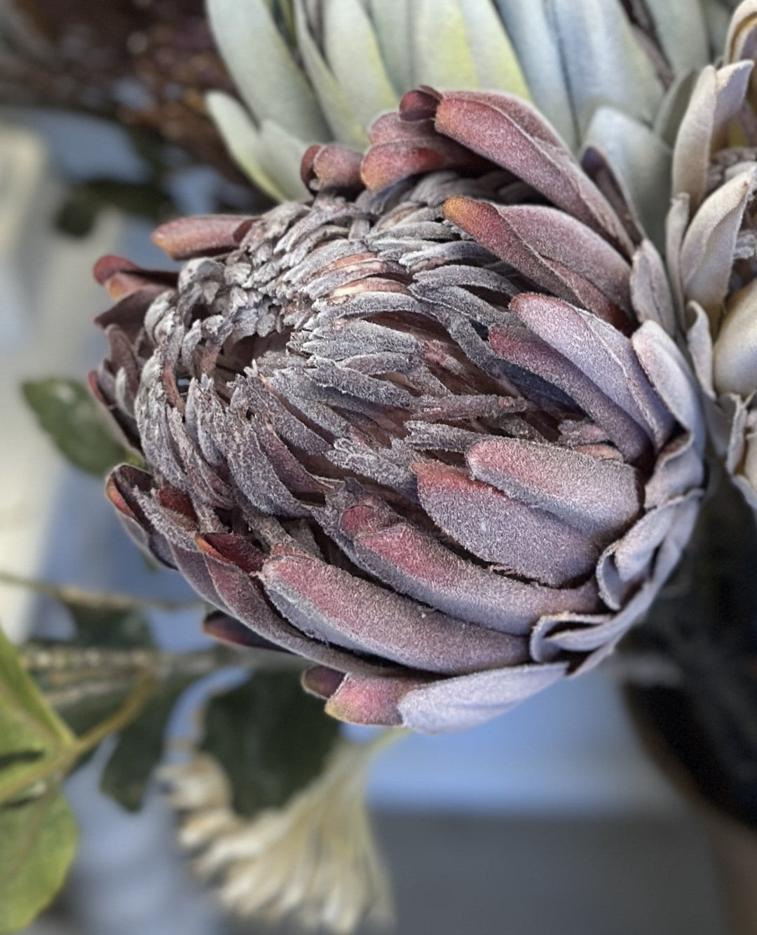 Close view of the purple king protea faux bloom and layered petals
