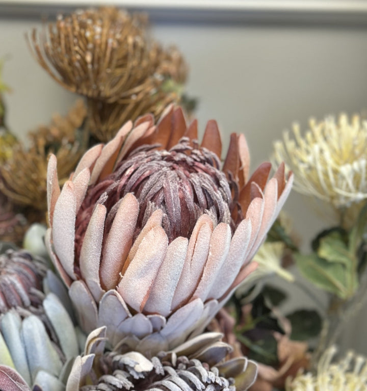 Close view of the blush pink king protea faux flower