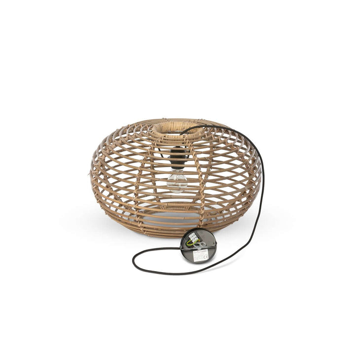 Woven rattan lamp with black cord on a white background