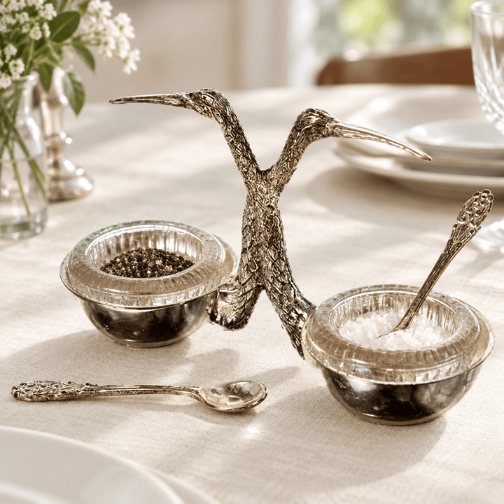 Stork salt and pepper cellar with spoons styled on an ivory linen dining table