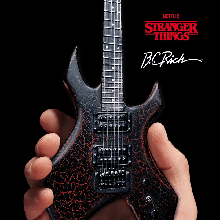 Stranger Things Eddie’s B.C. Rich Warlock Mini Guitar Replica held in hand, showcasing its iconic design and intricate craftsmanship.