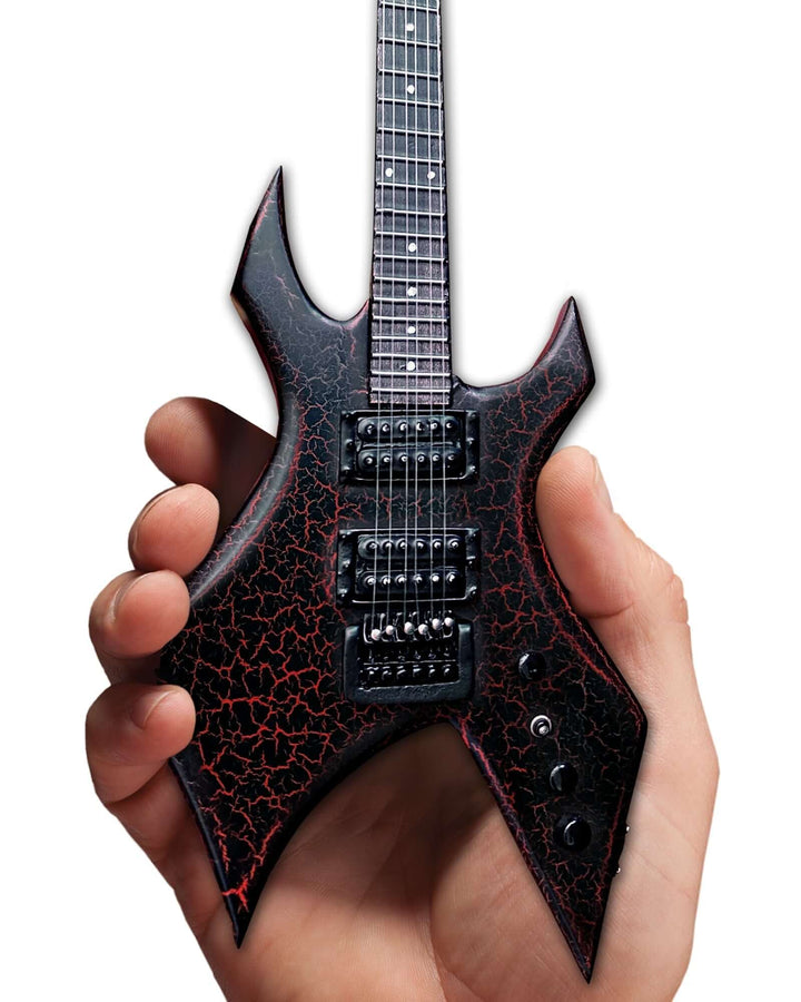 Hand holding the Stranger Things Eddie’s B.C. Rich Warlock Mini Guitar Replica, a 1:4 scale collectible model from the iconic TV show.