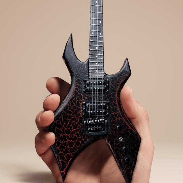 Close-up of Stranger Things Eddie’s B.C. Rich Warlock Mini Guitar Replica held in a hand, showcasing intricate details of the collectible.