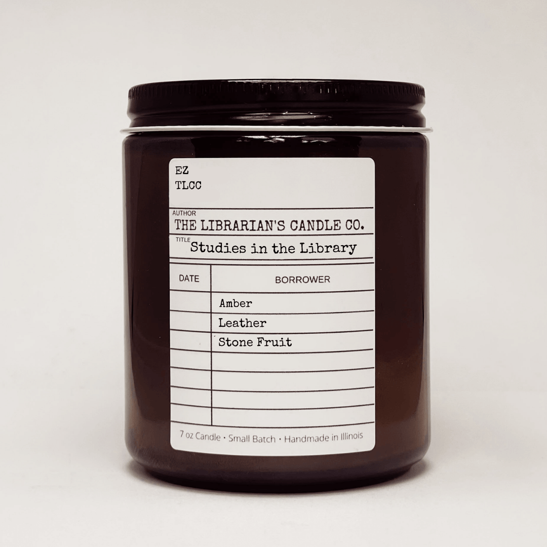 Studies in the Library Scented Candle: Amber, Leather & Stone Fruit with a vintage library card design.
