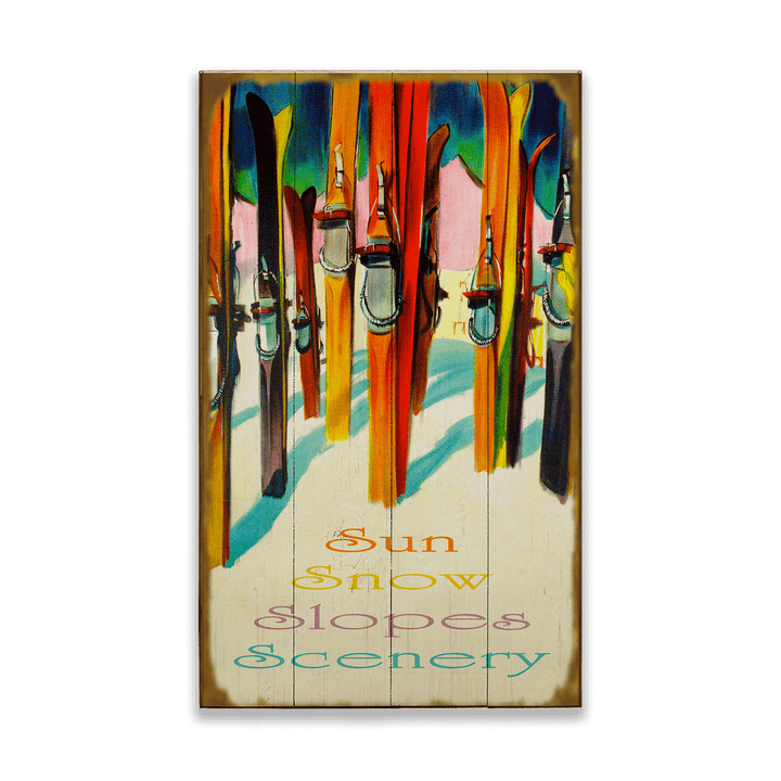 Decorative wall art with skis and snow-themed text on a wooden panel.