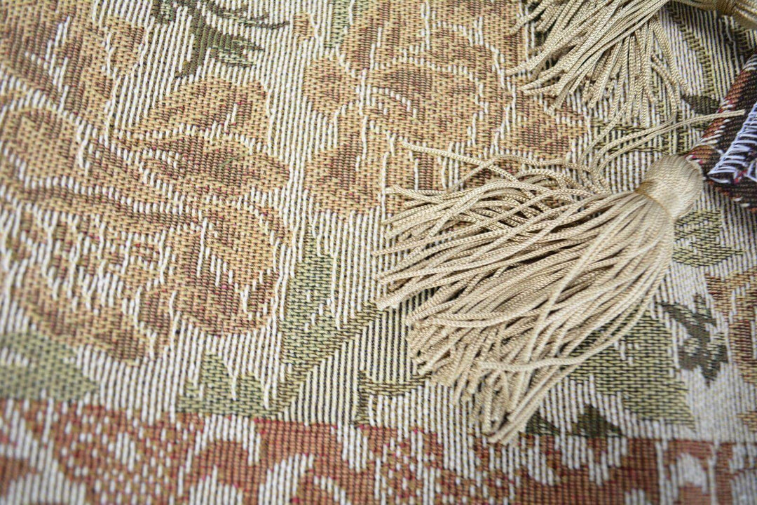 Close-up of DaDa Bedding Floral Nature Garden Beige Orange Spices Tapestry Table Runner (10072) with golden tassels, floral patterns.