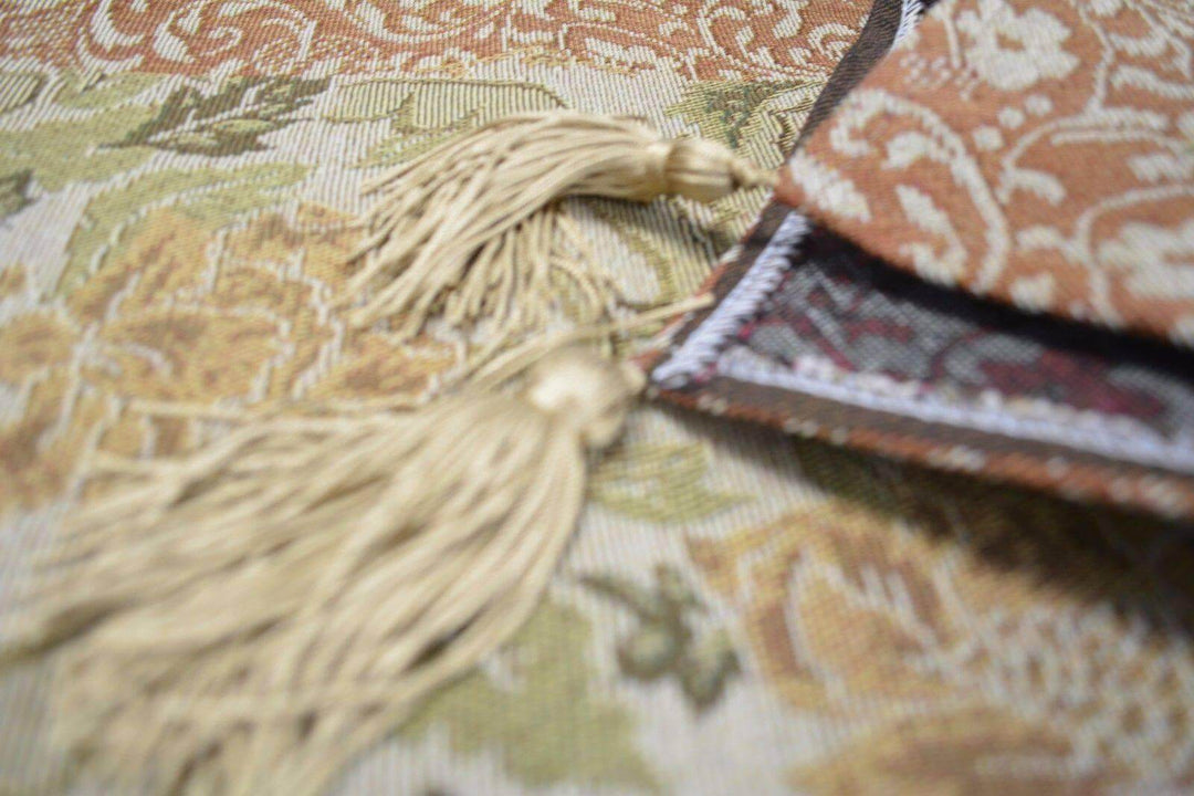 Close-up of DaDa Bedding Floral Nature Garden Beige Orange Spices Tapestry Table Runner (10072) with golden tassels.