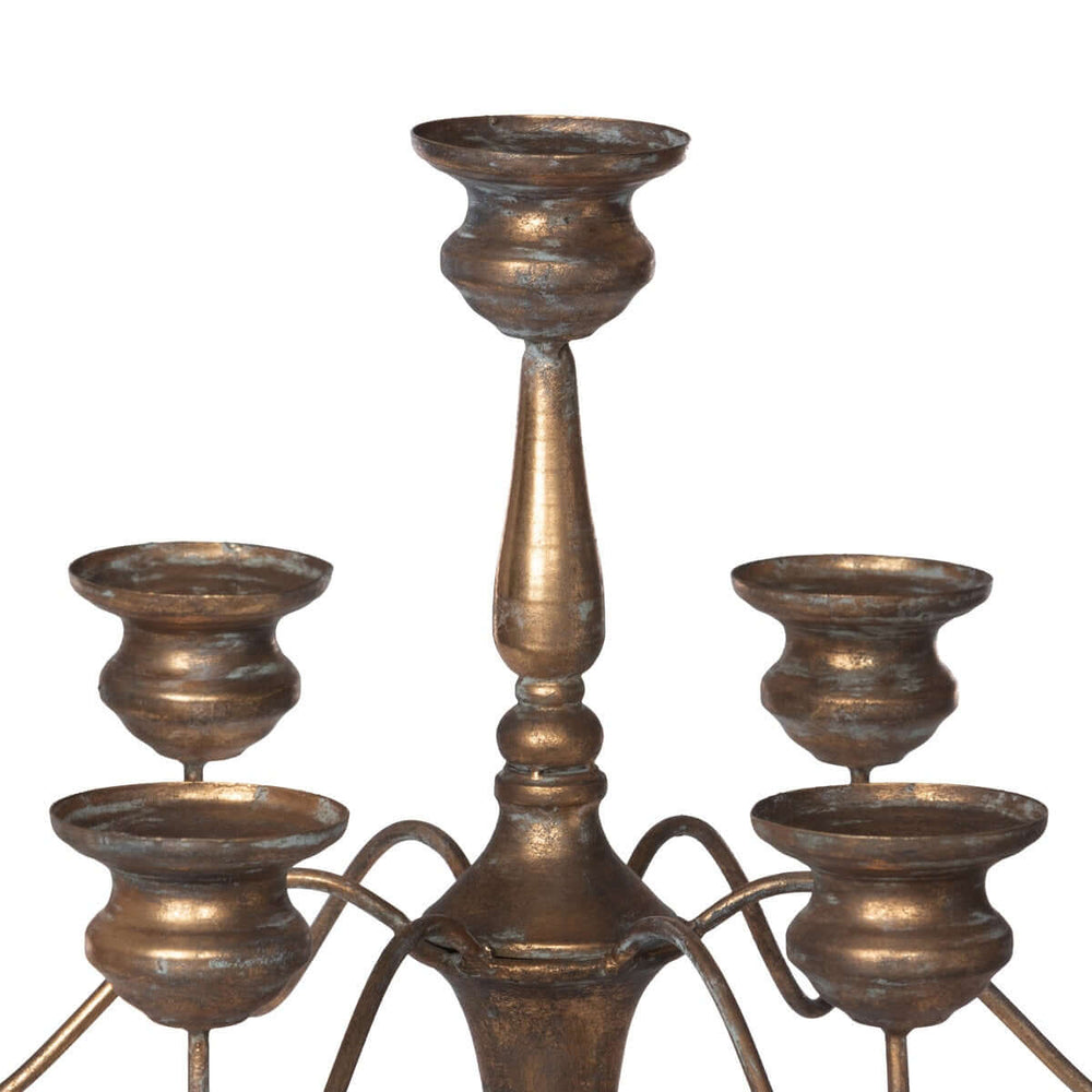 Tall vintage iron candelabra with intricate design for elegant event centerpieces, crafted with bronzed finish for romantic gatherings.