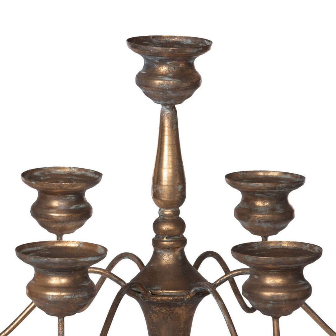 Tall vintage iron candelabra with intricate design for elegant event centerpieces, crafted with bronzed finish for romantic gatherings.