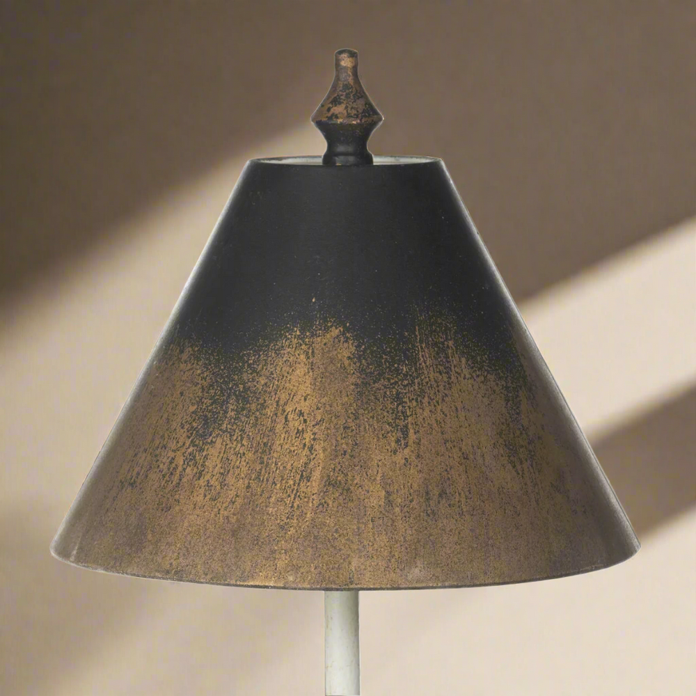 Vintage table lamp with black and gold shade, evoking timeless elegance and antique charm.