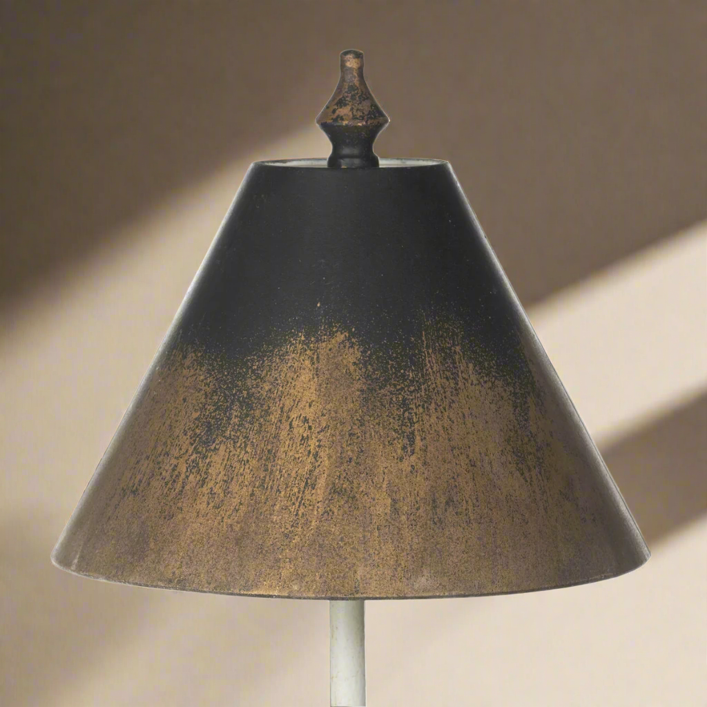 Vintage table lamp with black and gold shade, evoking timeless elegance and antique charm.