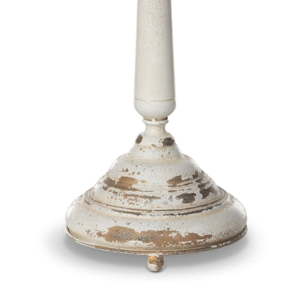 Distressed cream base of vintage table lamp with nostalgic antique detailing