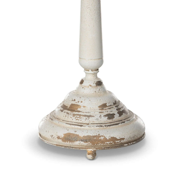 Distressed cream base of vintage table lamp with nostalgic antique detailing