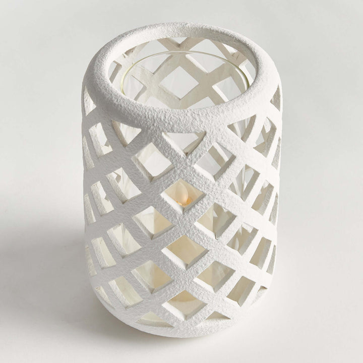 Terracotta hurricane candle holder with glass insert featuring a lattice design, ideal for holding tea lights.