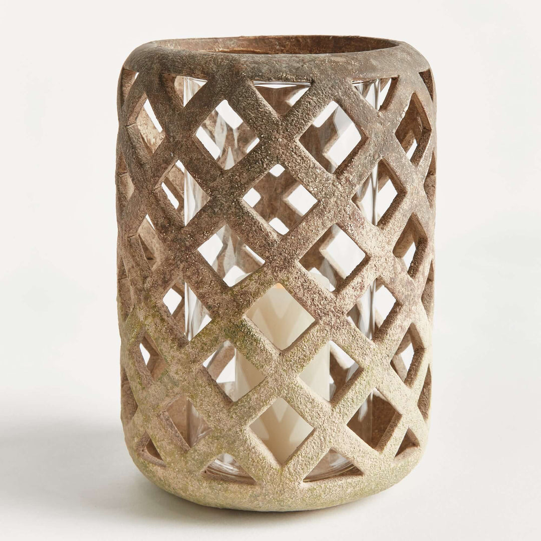 Terracotta hurricane candle holder with glass insert, featuring a hand-crafted lattice design.