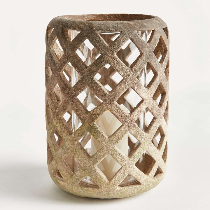 Terracotta hurricane candle holder with glass insert, featuring a hand-crafted lattice design.