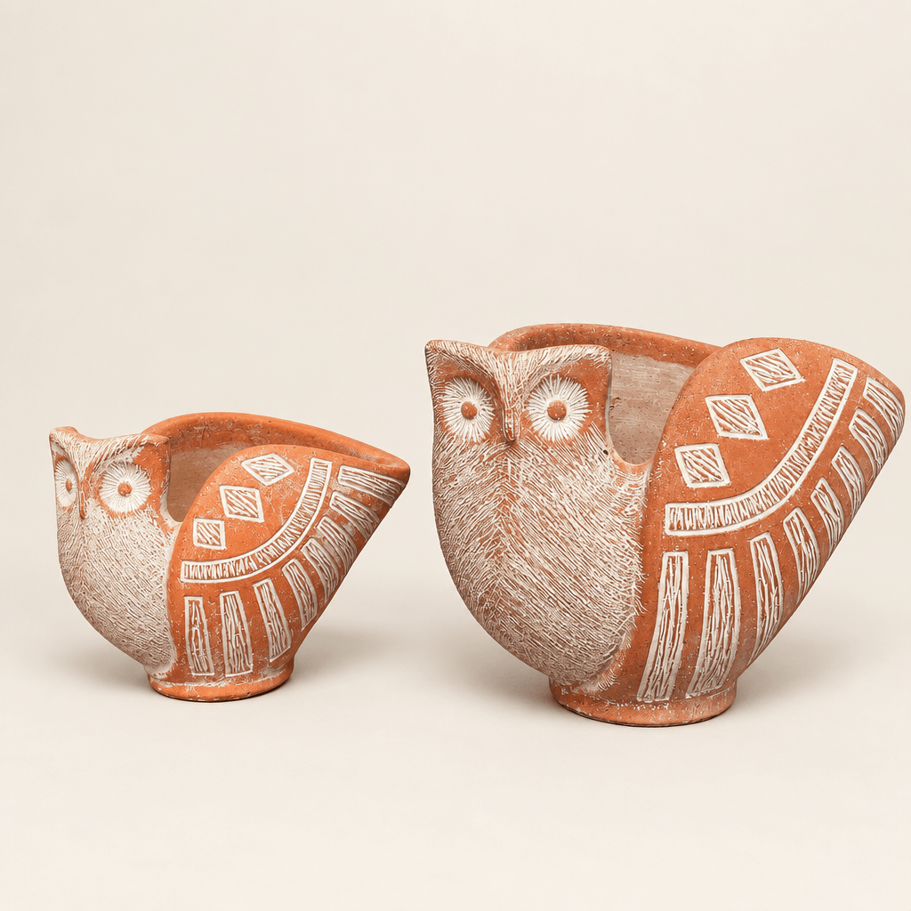 Small and large terracotta-tone cement owl planters with whitewashed feather details on an ivory background