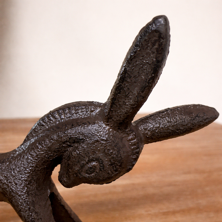 Close view of the donkey figurine's long ears and textured brown finish