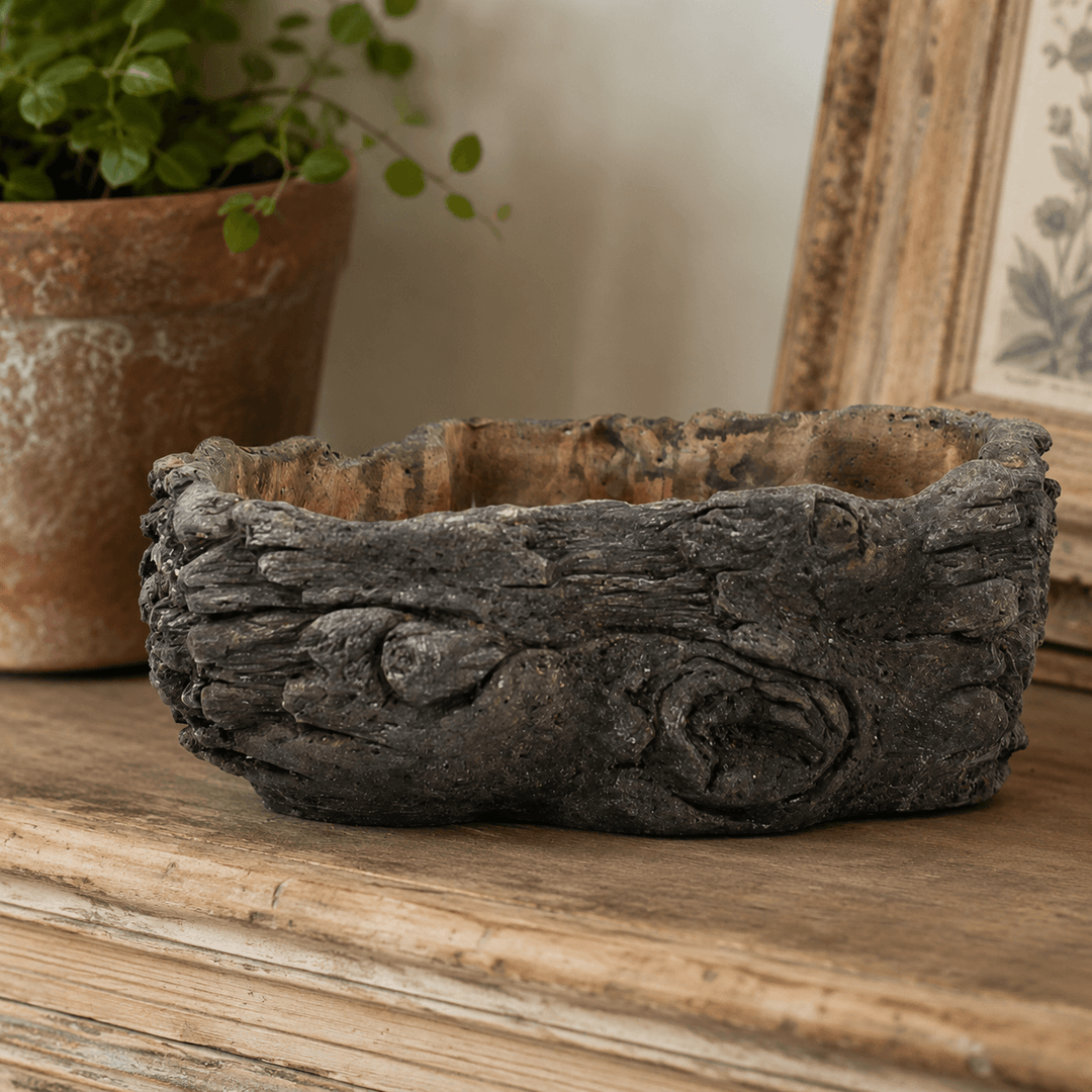 Empty Textured Cement Log Planter on a weathered wood table