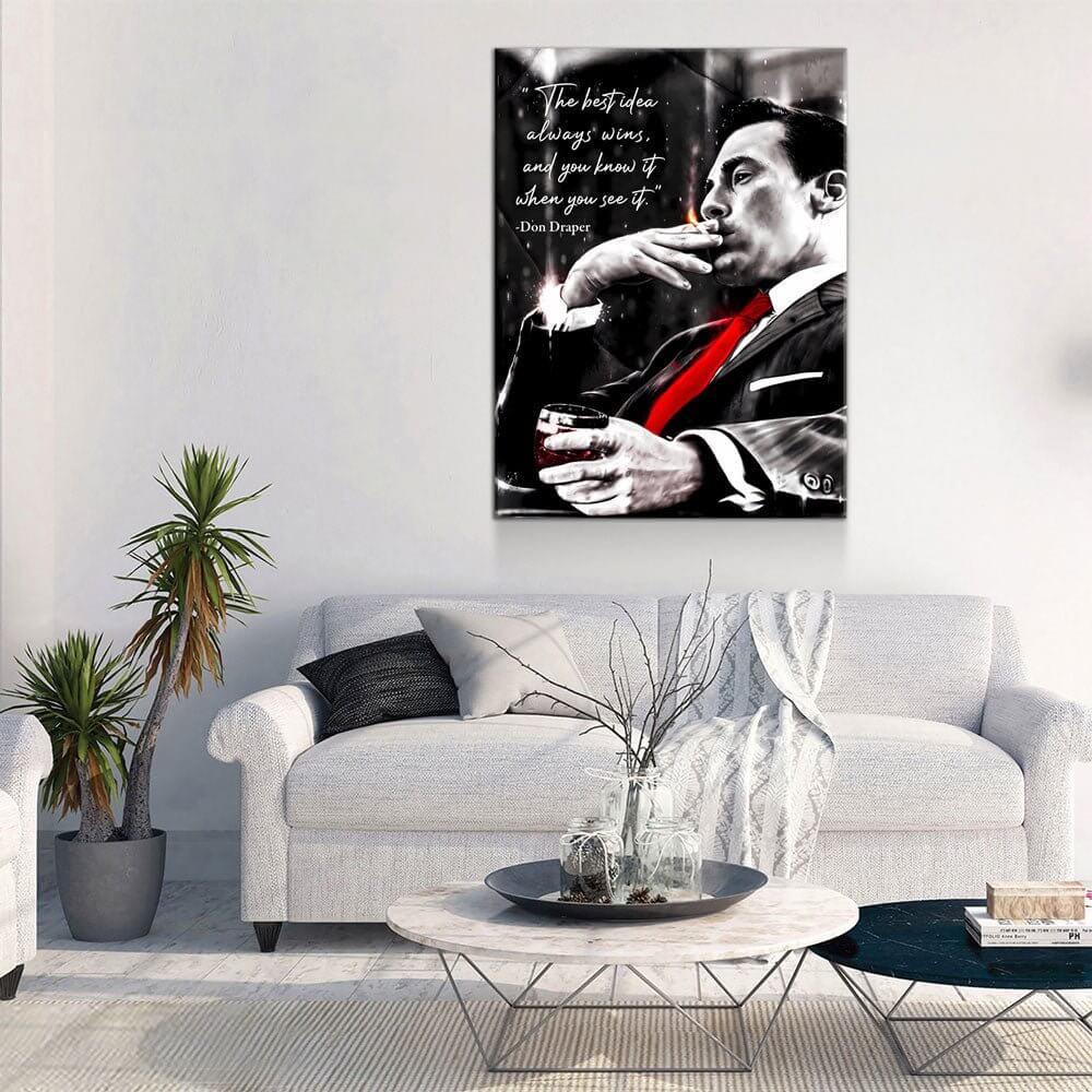 Don Draper “The Best Idea Always Wins” Canvas Wall Art hanging above a modern living room sofa with plants and a coffee table.