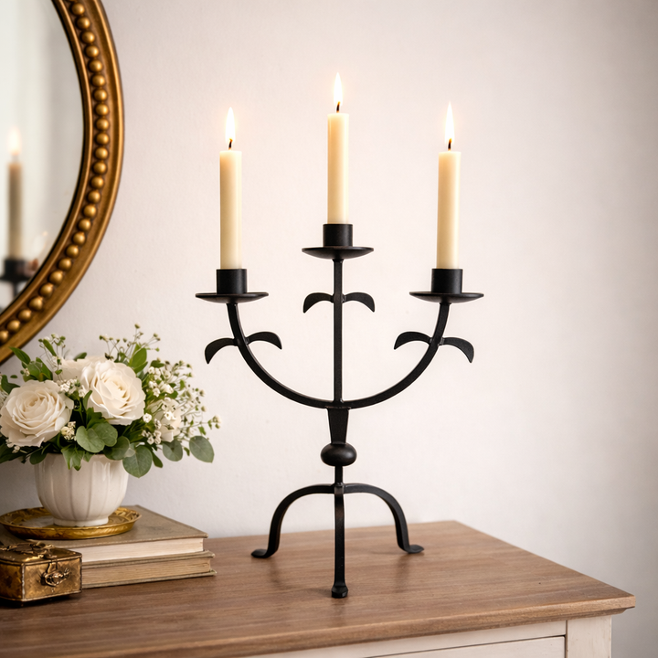 Three-Arm Iron Candelabra with Rustic Finish holding ivory taper candles