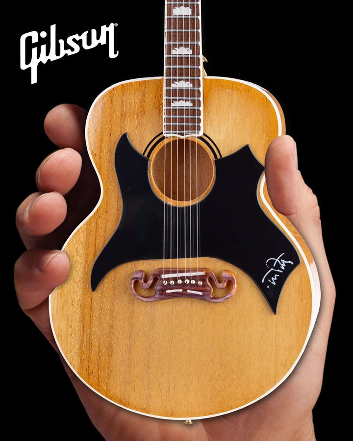 Hand holding Tom Petty Gibson SJ-200 Wildflower Mini Guitar Replica showcasing detailed craftsmanship.